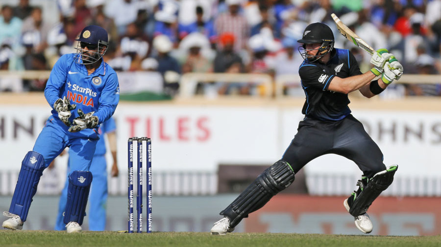 New Zealand's Martin Guptill, right, as Indian wicketkeeper and captain Mahendra Singh Dhoni watches during the forth one-day international cricket match between them in Ranchi, India, Wednesday, Oct. 26, 2016. (AP Photo/Rajanish Kakade)