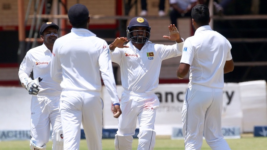 Sri Lanka's players celebrate a wicket during the fifth day of the test cricket match between Sri Lanka and Zimbabwe at the Harare Sports Club in Harare, on November 2, 2016. This is Zimbabwe's 100th test match since their international debut in 1992. / AFP / Jekesai Njikizana (Photo credit should read JEKESAI NJIKIZANA/AFP/Getty Images)